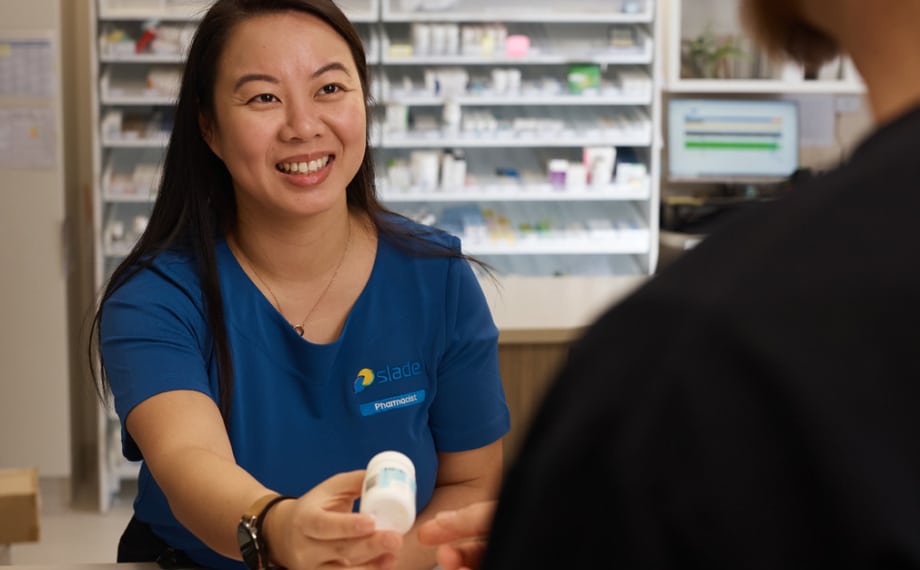 Pharmacist offering a patient medication