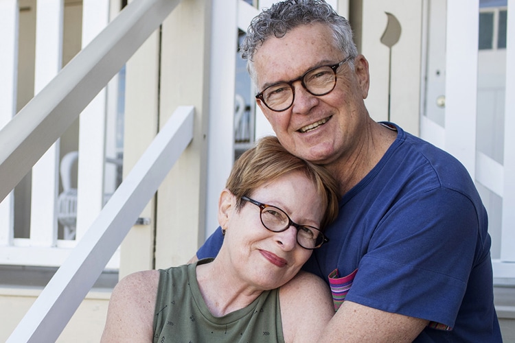 A couple holding each other while smiling